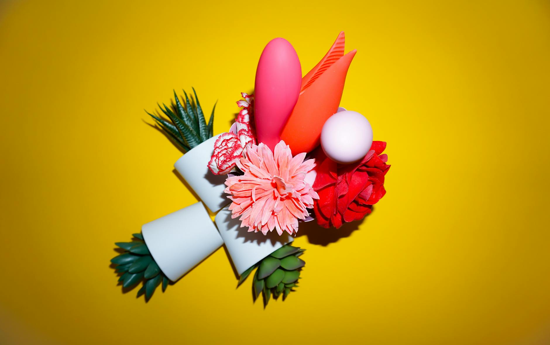 Woman holding colorful vibrators, exploring new paths to pleasure