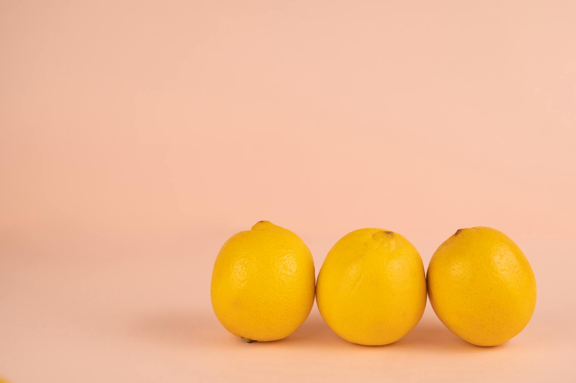 Fresh lemons on a soft pastel green background, symbolizing renewal and gentle self-discovery